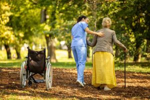 A social worker talking with an older adult in a bright, comfortable common room.