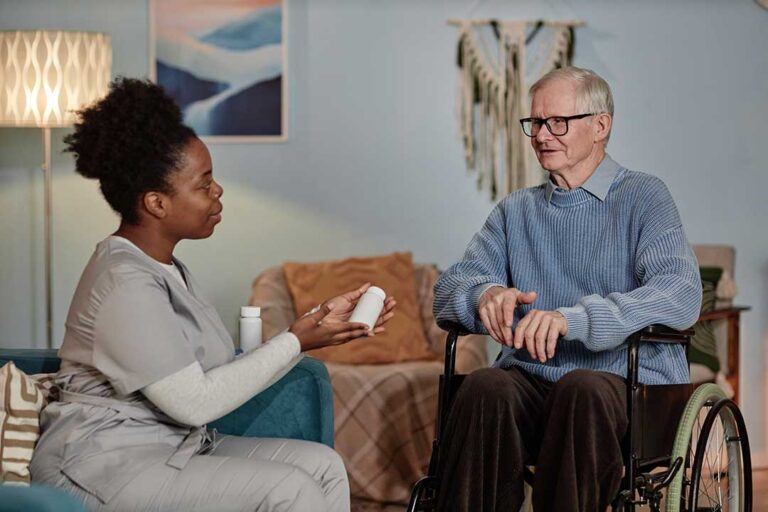 Older adults walking and stretching together in a bright assisted living community room.
